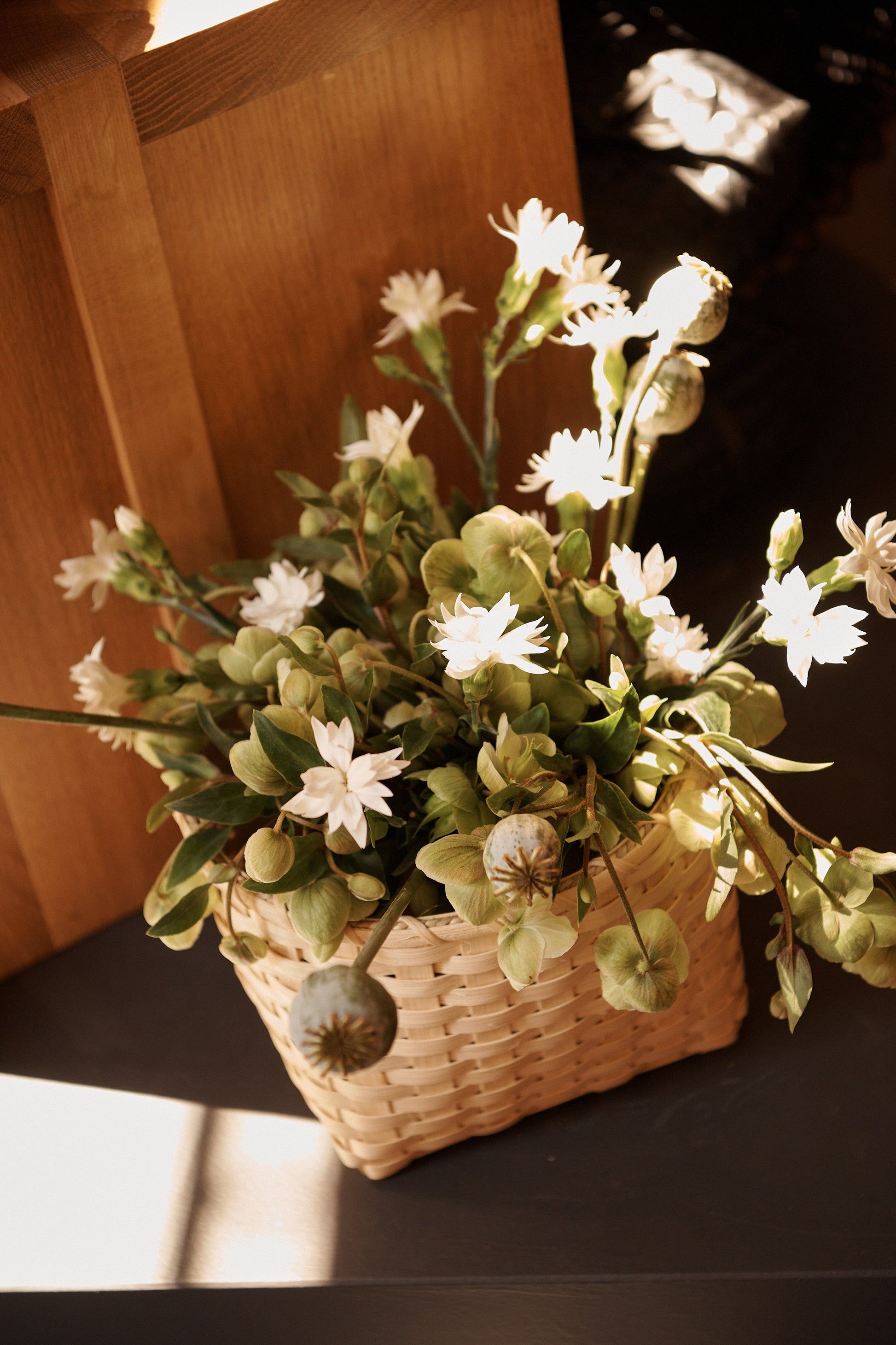 Underwater Weaving Studio Trail Basket made of woven natural fibers, featuring a sturdy handle and rustic design.