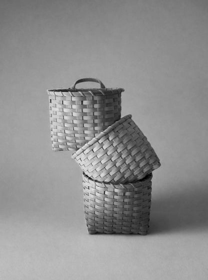 Underwater Weaving Studio trail basket made of natural woven materials with sturdy handles for outdoor use.