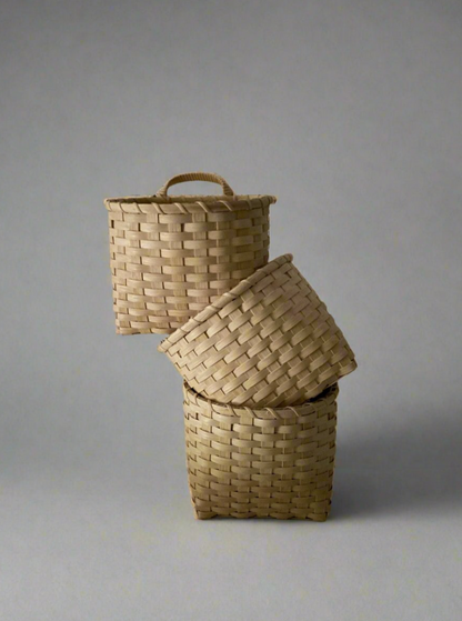 Underwater Weaving Studio Trail Basket made of natural woven materials, showcasing its sturdy handle and rustic design.