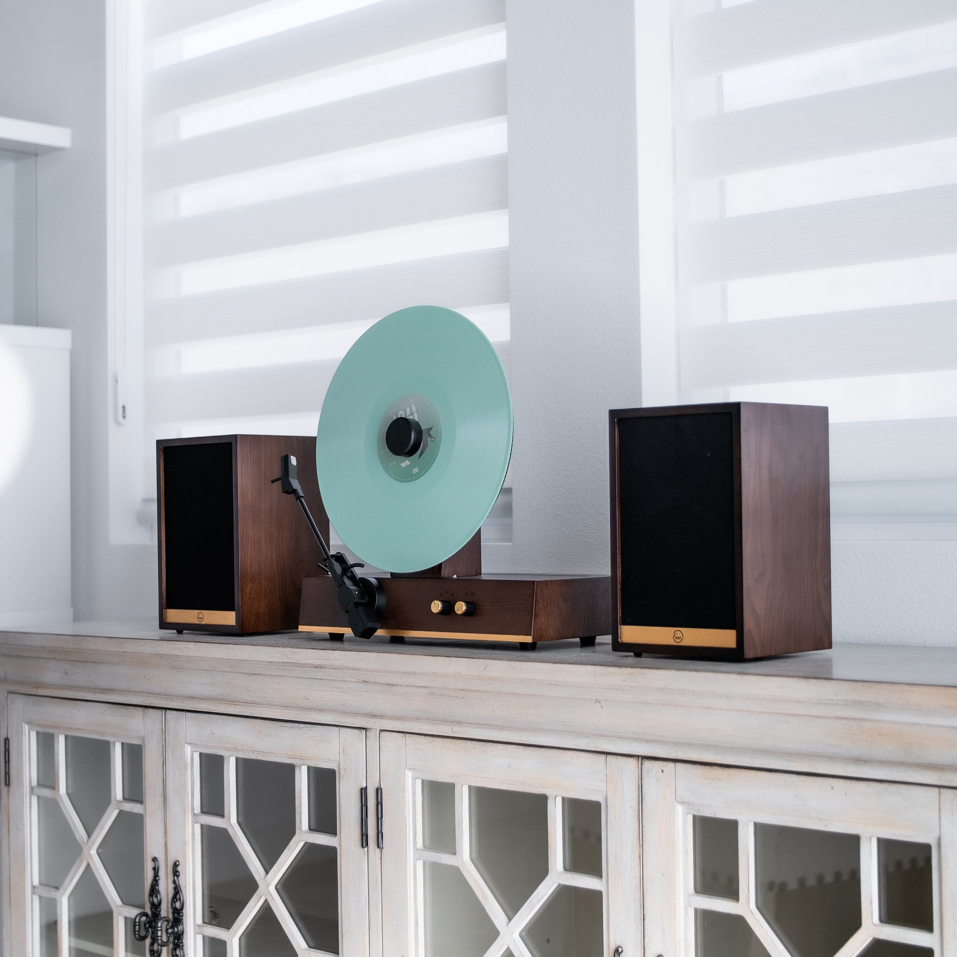 Fuse Audio GLD vertical vinyl record player with sleek design, featuring tonearm and control buttons on a modern turntable.