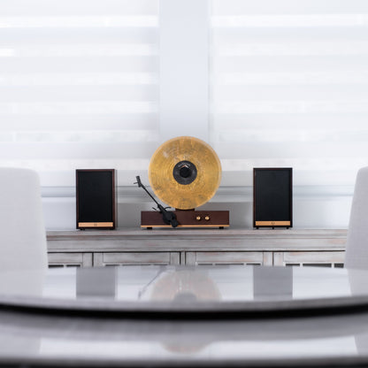 Fuse Audio GLD vertical vinyl record player on a display stand, showcasing its sleek design and turntable features.