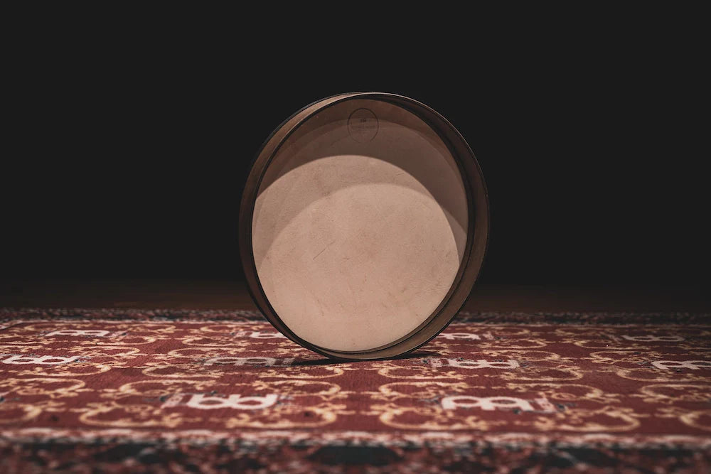 Hand drum in walnut brown with 18-inch diameter, showing textured surface and natural wooden finish, used for meditation and healing.