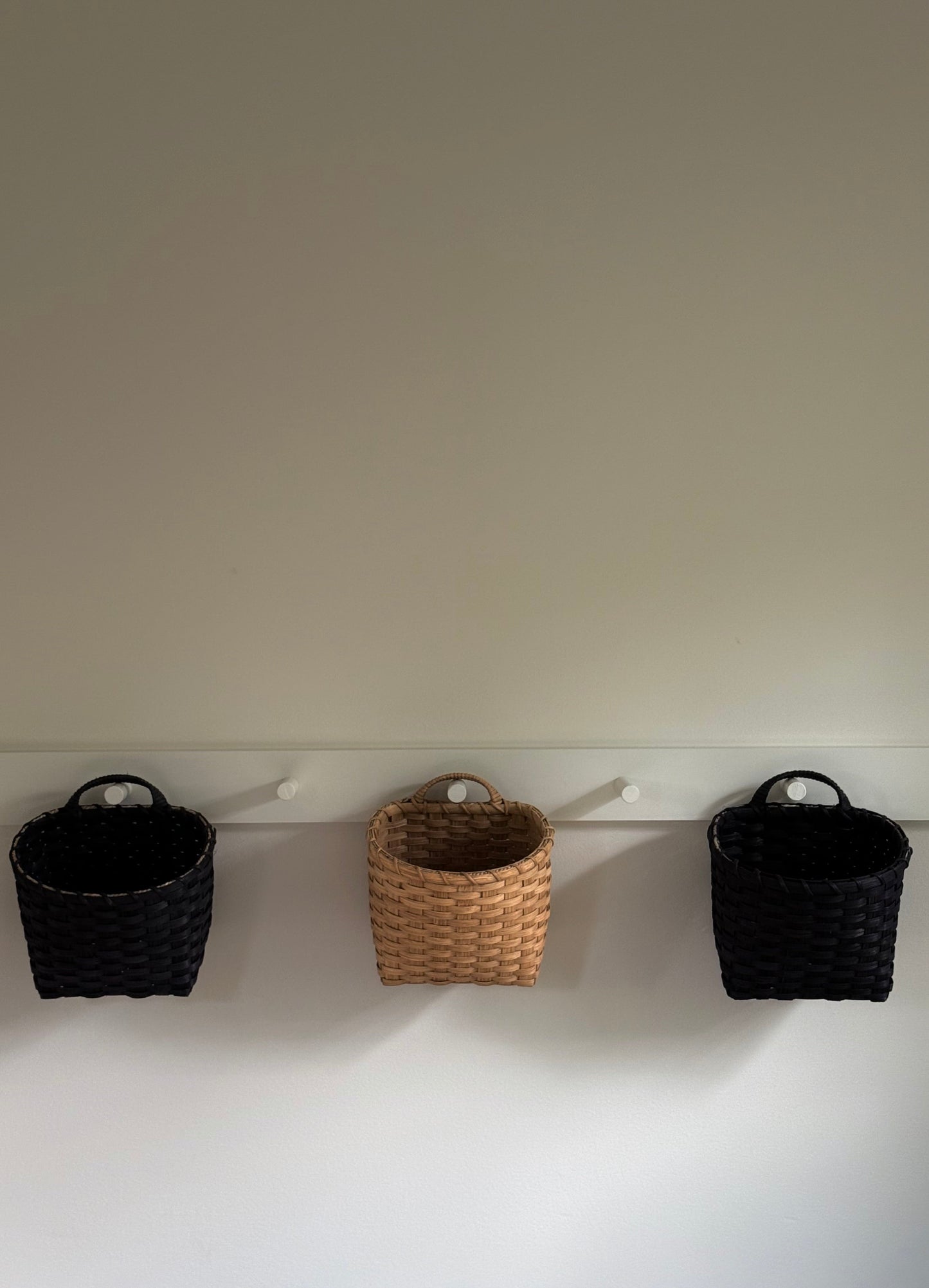 Underwater Weaving Studio trail basket made of natural woven fibers, featuring a sturdy handle and rustic design for outdoor use.