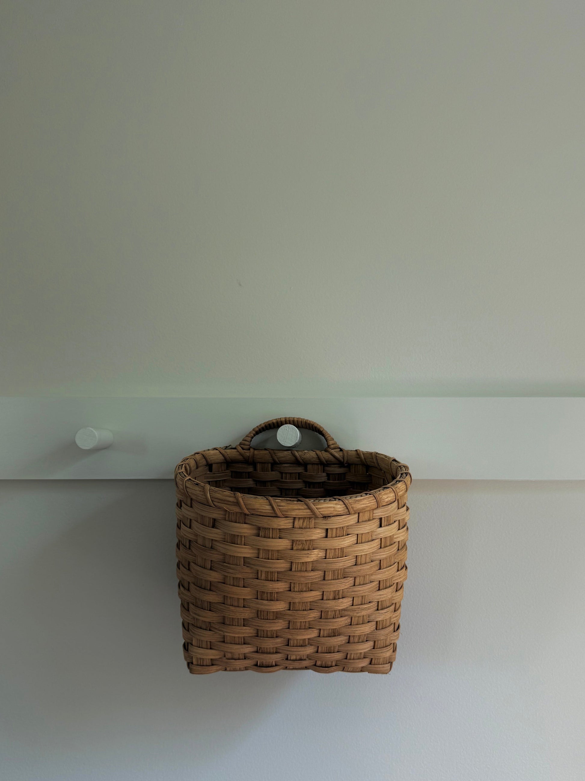 Underwater Weaving Studio trail basket with woven handle and natural fiber construction, ready for outdoor adventures.