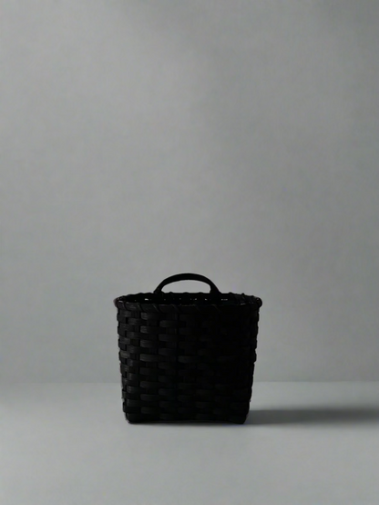 Black Trail Basket by UNDERWATER WEAVING STUDIO, woven basket with sturdy handle, ideal for outdoor storage or decor.