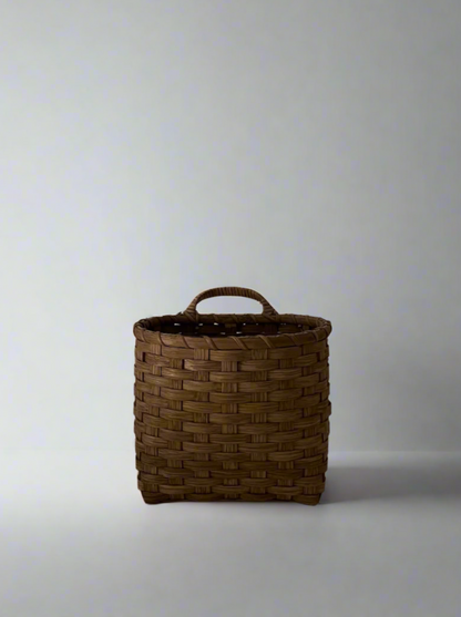 Smoked trail basket by UNDERWATER WEAVING STUDIO, woven basket with sturdy handle and detailed craftsmanship.