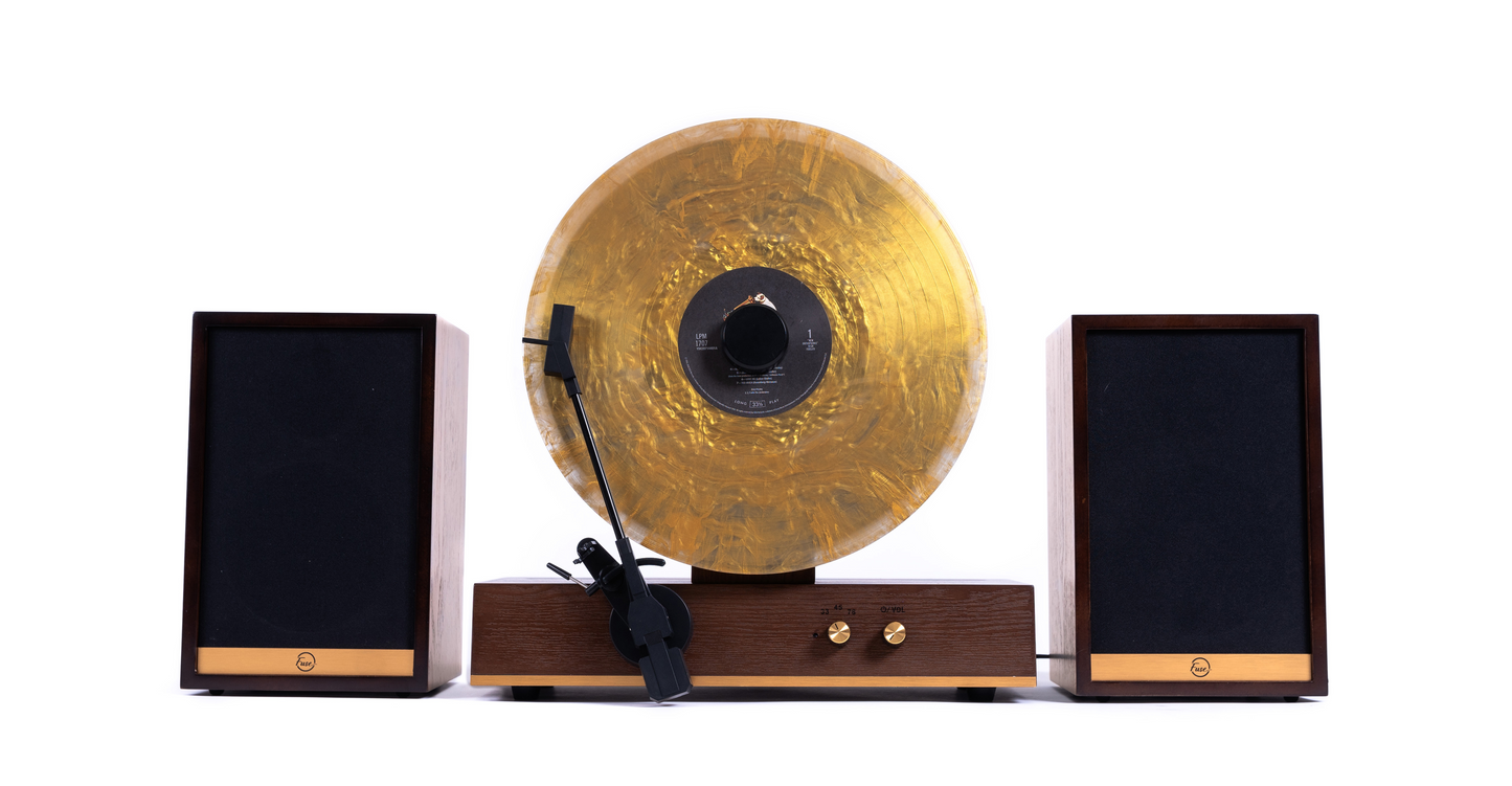 Fuse Audio GLD vertical vinyl record player in gold, showcasing a sleek turntable design with tonearm and record in view.