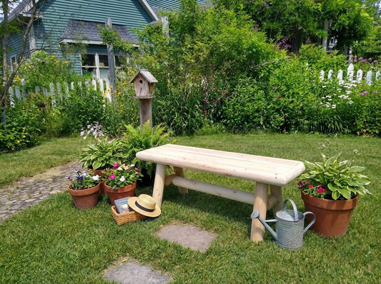 Rustic cedar farmhouse outdoor entryway bench with wooden slats and sturdy legs, perfect for porch or garden seating.