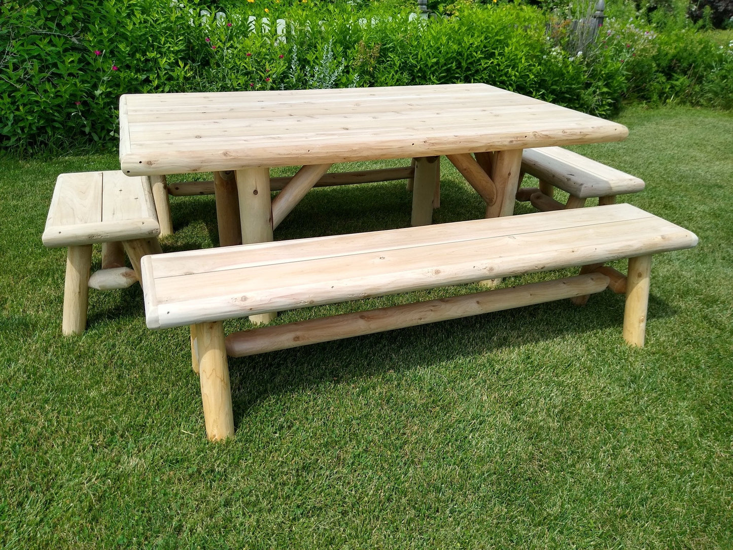 Handmade rustic outdoor picnic table with four benches by Cedar Creek Rustic Furniture, ideal for patio and garden dining.