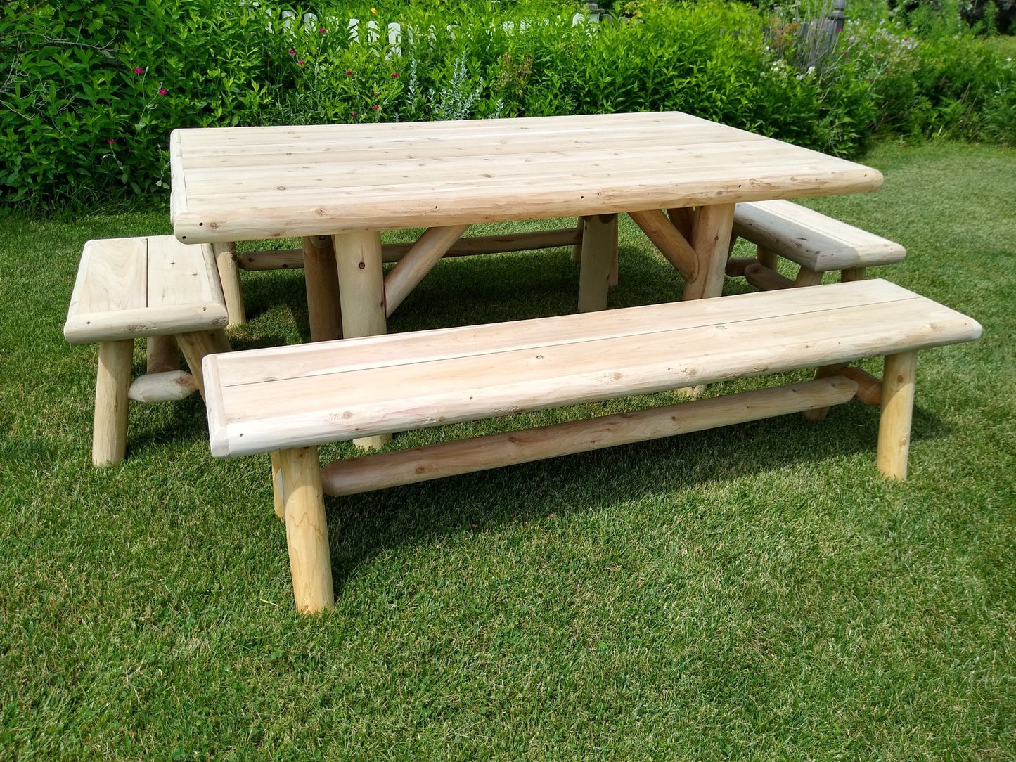 Handmade rustic outdoor picnic table with four benches by Cedar Creek Rustic Furniture, ideal for patio or garden gatherings.