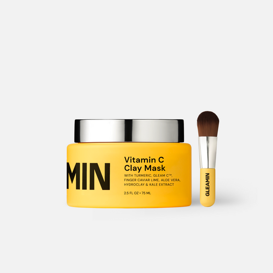 Gleamin Vitamin C Clay Mask in a jar, showcasing its creamy orange-colored face mask for brightening and detoxifying skin.