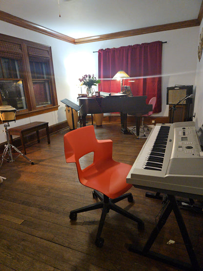 Interior of Ozaukee Talent Registrations' music rehearsal space showing soundproofed walls and musical equipment for band practice.