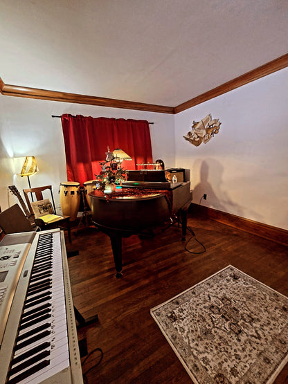 Music rehearsal space at Ozaukee Talent Registrations, showing a soundproof room with musical instruments and sound equipment.