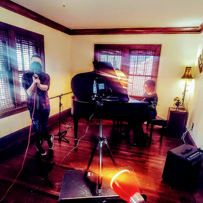 Music rehearsal space from Ozaukee Talent Registrations, showing a soundproof room with musical instruments and seating for musicians.