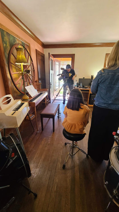 Music rehearsal space for rent by Ozaukee Talent Registrations, showing a soundproof room with musical instruments and recording equipment.