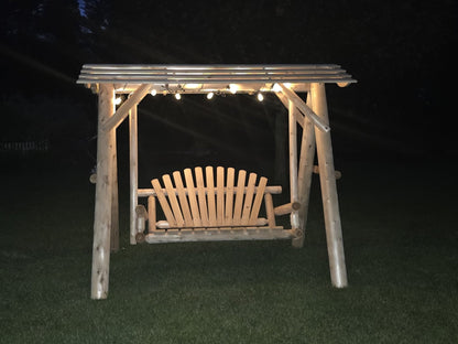 Wooden porch swing with canopy by Cedar Creek Rustic Furniture, featuring a sturdy wooden frame and comfortable seating.
